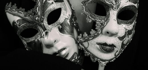 Dramatic black and white photo featuring an elegant woman holding two ornate Venetian masks.