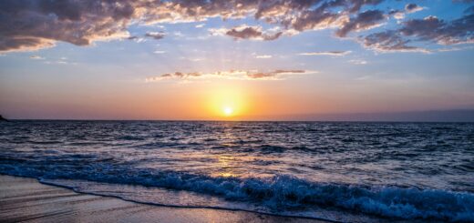Captivating sunset over the ocean with vibrant colors, serene waves, and a peaceful sky.