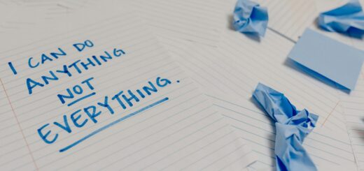 Motivational message on a page surrounded by crumpled papers and blue sticky notes.